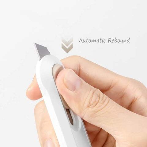Demonstration of Four Piece Utility Knife Box Cutter Set With Retractable Letter Opener And Cardboard Cutter Razor Knife For Boxes And Packaging, Durable Carbon Steel Blades, Smooth Mechanism, Comfortable Grip For Office And Home Use showing automatic rebound feature.