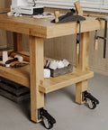 Wooden workbench with retractable workbench casters and quick-release caster plate set four pack installed for mobile use