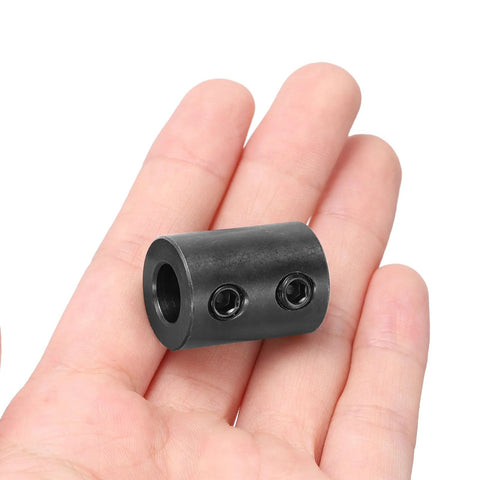 Rigid shaft coupling with a 3/8 inch bore, 3/4 inch outer diameter, and 1 inch length displayed on hand