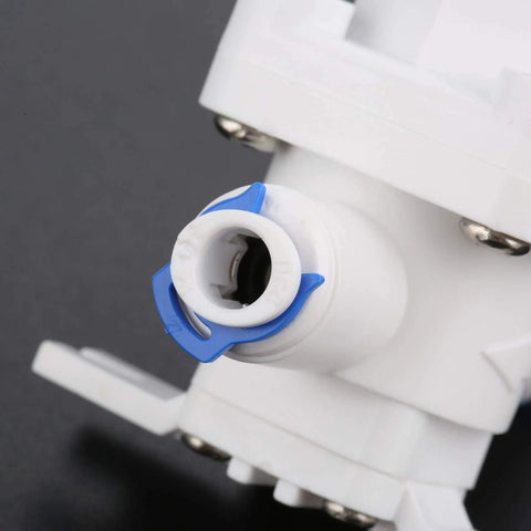Close-up of RO water pressure regulator and flow regulator for reverse osmosis systems one quarter inch quick connect reducing valve.