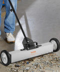 Effortless, heavy duty rolling magnetic sweeper with a 24 inch wide magnet and 50 lb pickup capacity, removing debris on floor