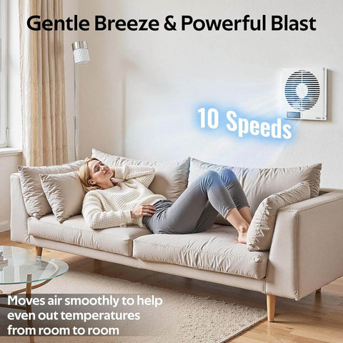 Woman on sofa showing 8 Inch Through Wall Room To Room Fan With Remote 320 CFM Air Transfer Temperature Control Reversible Airflow 10 Speeds Quiet Exhaust Vent For Bedroom Laundry And Kitchen From Windigaga installed on wall