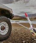 Three Quarter Ton Rope Puller Come Along Winch With 100 Ft Rope securing a vehicle on rugged terrain
