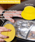 Person using 5 Inch Hook And Loop Sanding Discs Set 50 Pcs For Wet Dry Polishing on car headlight with yellow hand sanding block.