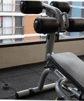 Weightlifting bench with Four Pack Round Rubber Bumpers for Gym Equipment and Home Fitness Machines on the floor.