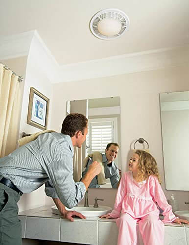 Installed Round White Bath Exhaust Fan With Light And Glass Lens, 100 CFM, 3.5 Sones, 4 Inch Duct, 100 Watt Light in bathroom ceiling.