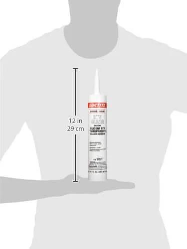 Automotive RTV clear silicone adhesive sealant 300 ml tube held by figure illustrating size comparison