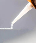 Close-up of Clear One Hundred Percent RTV Silicone Sealant for Vertical and Overhead Installations being applied from a 10.2 oz cartridge.