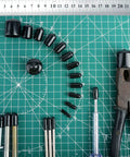 Round Rubber End Caps Set 158 Pieces With 12 Sizes on a green grid mat with tools