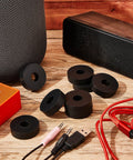 Set of 16 thick rubber isolation pads with 1.5 inch outer diameter, 0.5 inch inner hole, and 0.4 inch thickness displayed on wooden surface.