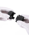 uxcell L-jaw coupling halves, 1/2–5/8 in, black plastic, 2 pieces held by gloved hands