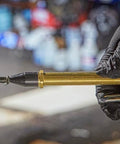 Lever Style Grip Air Blow Gun With Rubber Tip, close-up of brass nozzle, held in gloved hand, for industrial debris clearance