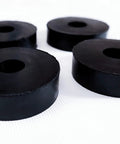 Four Pack Rubber Isolation Feet Pads For Vibration Damping, 1.5 Inch Outer Diameter, 0.5 Inch Inner Diameter, 0.4 Inch Thick, shown on surface