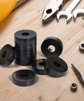 Durable rubber washers set delivers reliable vibration damping and quiet operation for machines, motors, and mounts; includes 30 flat washers sized 1.5 in OD, 0.5 in ID, 0.375 in thick for spacer and isolation needs. Displayed on a wooden surface with tools.