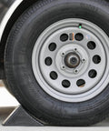 Beefy Rubber Wheel Chock For Cars Trailers RVs And Utility Vehicles With Reinforced Grip Weather And Chemical Resistant 5x6x5 Inch Tire Stopper For Secure Parking And Service Bays Buyers Products WC1467A securing vehicle tire.