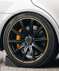 Rugged 2 Pack Solid Rubber Wheel Chocks for RVs, Campers, Trailers and Trucks, Heavy Duty Tire Blocks in use with car tire.