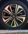 Heavy Duty Rubber Wheel Chocks 4 Pack For Trailers And RVs Ideal For Cars Travel Trailers Trucks And ATVs 6.3 X 4 X 4 Inches UV And Oil Resistant All Weather Black Chocks By CertBuy, visible securing a car wheel