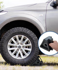 Heavy Duty Rubber Wheel Chocks Set Of 4 For Cars Trailers RVs Trucks And ATVs Premium Non Slip Tire Stoppers 8 X 4 X 6 Inches Durable Solid Rubber Black positioned under car tire
