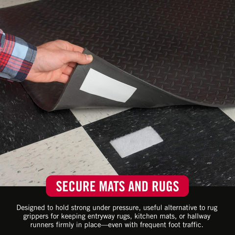Close-up of adhesive strip securing a rug on a tiled floor, emphasizing Heavy Duty No Nail Stick On Adhesive Strips For Hassle Free Quick Mounting Indoor Outdoor Use 4 Inch By 2 Inch 2 Pack Holds Up To 10 Lbs On Smooth Surfaces Great For Plastic Metal Painted Wallboard