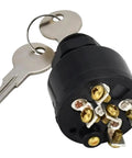 Keyed lock cylinder, black, front view with two keys on a ring and visible brass screw terminals.