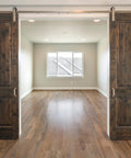 Wooden sliding doors with visible track system in a spacious room, showcasing installation for Sliding Door Nylon Wheel Pulleys 30mm.