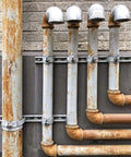 Ten-piece universal tube clamps deliver secure, corrosion-resistant support for Unistrut channels; 2 inch wall mount conduits, bolts and nuts included, galvanized steel for long lasting electrical and plumbing runs, supporting metal pipes on industrial wall.