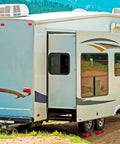 RV Leveling Blocks Kit for Dual Axle Travel Trailer With Ramp Chocks Rubber Mats Bubble Level and Carry Bag Heavy Duty HDPE Non Slip System Adjustable From One Half Inch To Four Inches In Minutes By OULEME installed under dual axle travel trailer in a campsite.