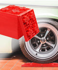 10 Pack Heavy Duty RV Leveling Blocks For Campers And Trailers Interlocking red plastic blocks next to RV wheel
