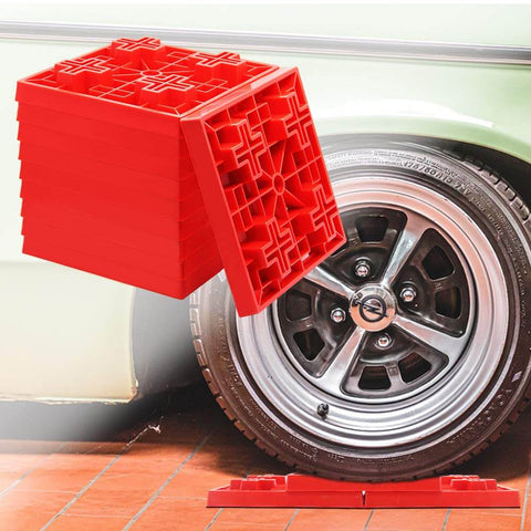 10 Pack Heavy Duty RV Leveling Blocks For Campers And Trailers Interlocking red plastic blocks next to RV wheel