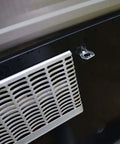 Close-up of RV water heater cover with visible stainless steel cam lock fastener, designed to replace a broken water heater door latch quickly.