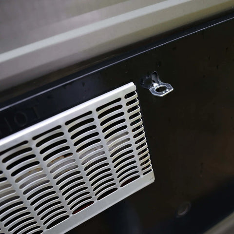 Close-up of RV water heater cover with visible stainless steel cam lock fastener, designed to replace a broken water heater door latch quickly.