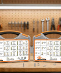 Two cases of 612-Piece SAE Grade 8 Bolts And Nuts Kit, Yellow Zinc Plated, on a workbench with tools in the background