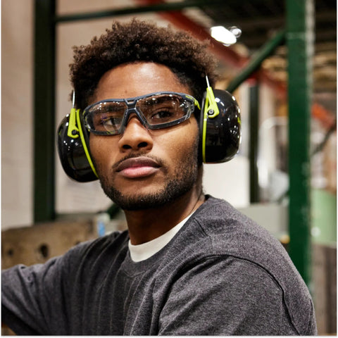 Man wearing Safety Glasses With Removable Foam Gasket TruShield Anti Fog Adjustable Fit and earmuffs in workshop.