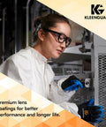 Worker wearing eyewear and gloves operating machinery in a workshop setting.