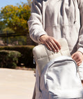 Person placing Nylon Puffy Zipping Laptop Sleeve 9.75 By 13 Inches Fits Most Screens Up To 14 Inches Sand Beige into backpack