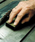 Person using Sanding Block 3 Pack With Fine Medium Coarse Grits Shaping And Rust Removal on metal surface near saw blade