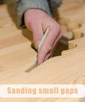 Close-up of hand using Double Sided Sanding Pads Kit 30 Pcs 2x2 In For Plastic And Acrylic Grit 320 600 on wooden surface