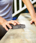 Person sanding wood with 120 grit from Sanding Sponge Set 4 Pack 60 80 120 220 Grit For Wood Metal Drywall.