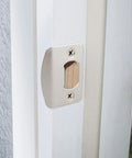 Installed view of universal door strike plate with adjustable latch, 2-pack in satin nickel, screws included, designed to replace worn strike hardware.