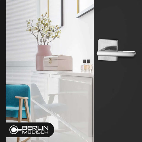 Room with black door featuring Dummy Lever Door Handles 2 Pack For Closet And French Doors, satin nickel finish, slim square non turning design.