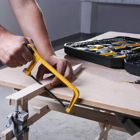 Man using yellow hacksaw with 228 Piece Socket Wrench Auto Repair Tool Set With Mixed Hand Tools In Durable Plastic Toolbox