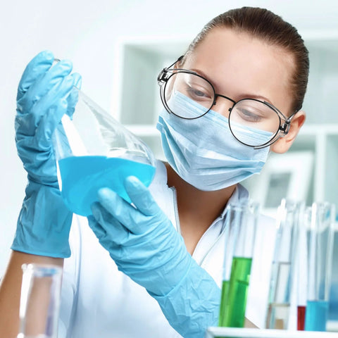 Scientist wearing Slip On Safety Glasses Side Shields 2 Pairs Transparent Anti Slip Protectors while handling lab liquids