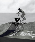 Skater performing a jump on half-pipe with Vortrack logo in foreground, monochrome image