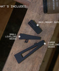 Scope Leveling Tool Kit With Base And Two Wedges For Precise Vertical Alignment While Mounting A Rifle Scope This Leveling System Helps You Get A Rock Solid Sight Picture And Quick Adjustments On Any Receiver By Monstrum showcasing rail/mount guide, small and large leveling wedges on wooden surface.