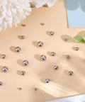 5 Size Set Of Screw Ball Backings For Threaded Posts 304 Stainless Steel Round Earring Backs scattered on a surface