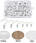 Assorted white hooks with screws for ceiling, wood, and wall, organized in a plastic storage box.