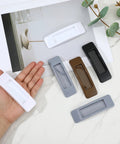8 Pcs Plastic Cabinet Drawer Handles Self Adhesive 4 Color Set displayed on table with hand holding one handle