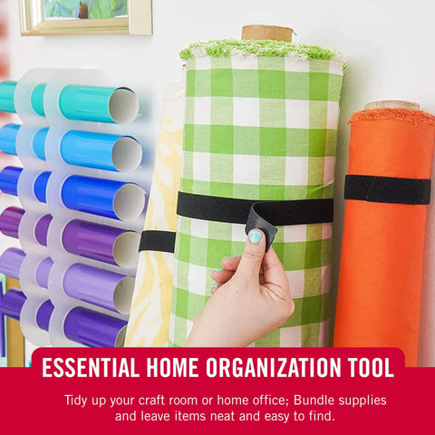 Hand securing fabric roll with One-Wrap Double-Sided Self Gripping Hook And Loop Tape Roll For Cable Management on a shelf.