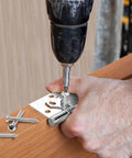 Image of a hand installing a hinge with a drill, using 200 Pcs #6 Wood Screws Assortment Kit Made from 304 Stainless Steel.