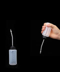 Sewing Machine Oil Dispenser 120ml Two Pack With Screw On Cap Extended Spout Angled Nozzle shown in hand and upright position